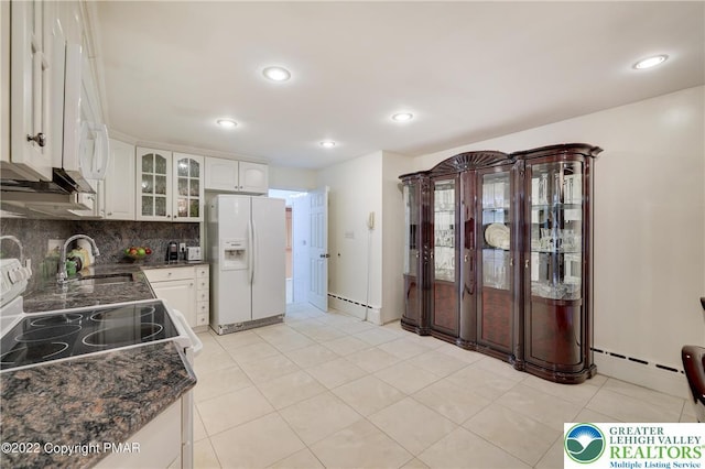 kitchen featuring a sink, glass insert cabinets, white cabinets, and white refrigerator with ice dispenser