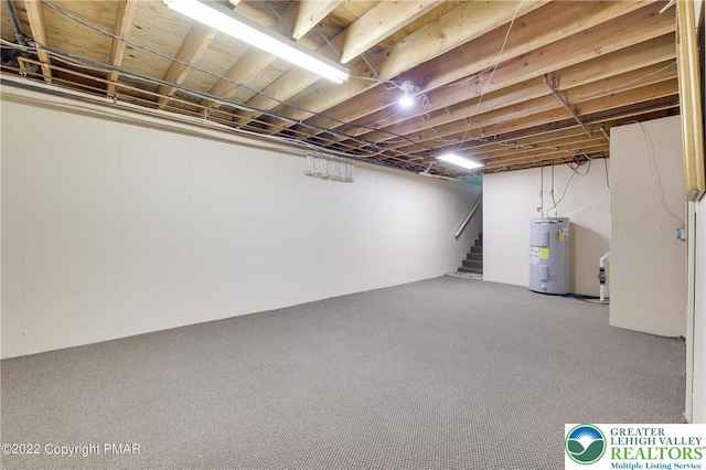 finished below grade area with water heater, carpet, and stairs
