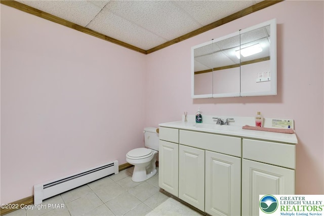 bathroom featuring tile patterned flooring, baseboard heating, vanity, toilet, and ornamental molding