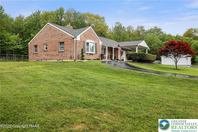 single story home featuring fence, a chimney, a front lawn, and brick siding