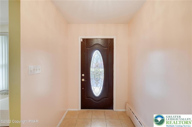 foyer entrance with baseboards, a baseboard radiator, and light tile patterned flooring