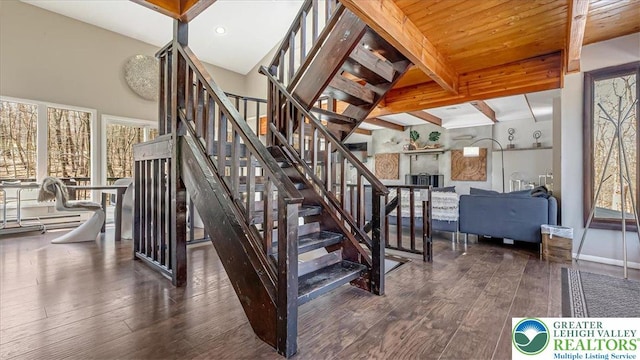stairs with wood-type flooring, baseboards, and beam ceiling
