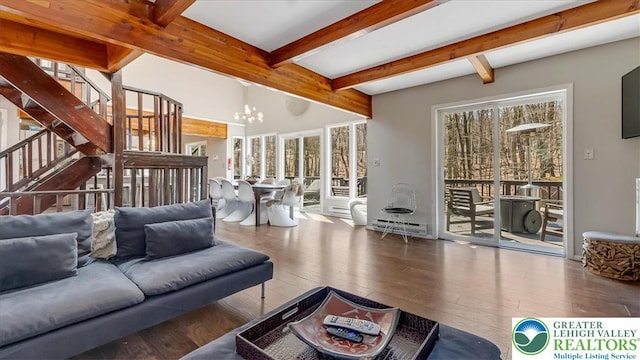 living area with beamed ceiling, a notable chandelier, plenty of natural light, and hardwood / wood-style floors