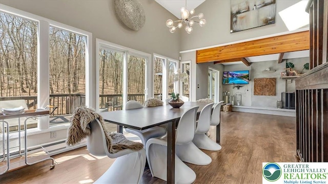 sunroom with beamed ceiling, an inviting chandelier, wood finished floors, and high vaulted ceiling