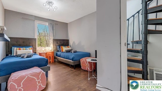 bedroom featuring visible vents and wood finished floors