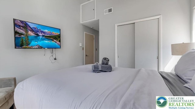 bedroom featuring a closet and visible vents