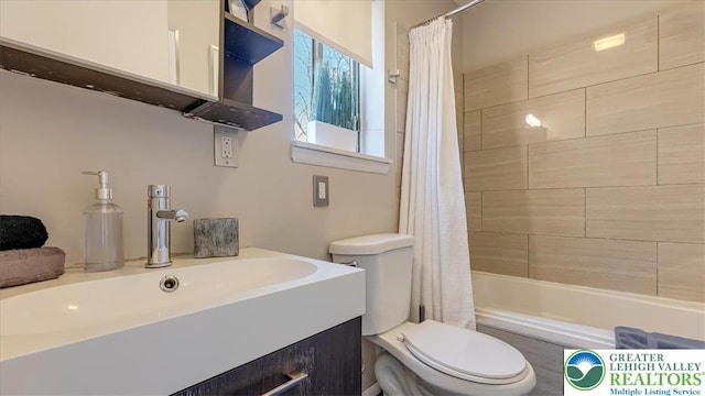 full bathroom featuring vanity, shower / bath combination with curtain, and toilet