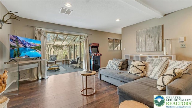living area featuring beam ceiling, recessed lighting, baseboards, wood finished floors, and visible vents