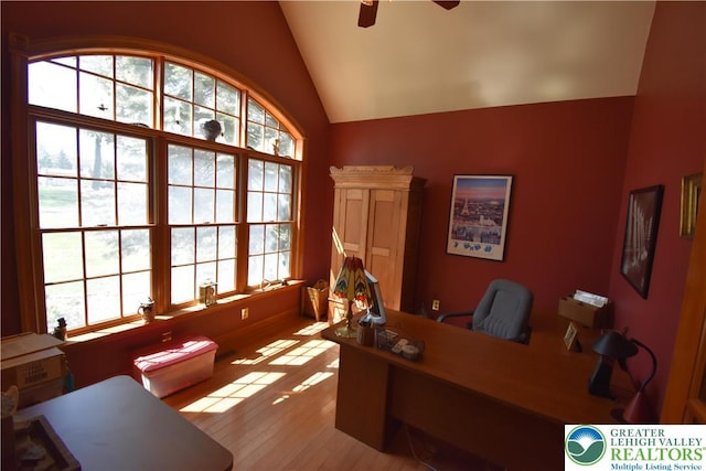 office area with light wood-style flooring, ceiling fan, and vaulted ceiling