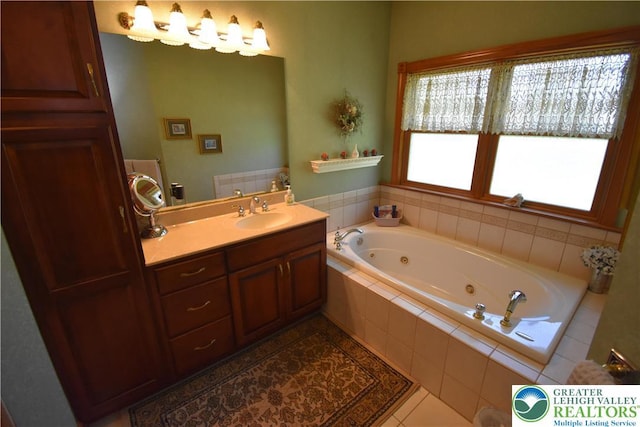 full bath with vanity, tile patterned floors, and a jetted tub
