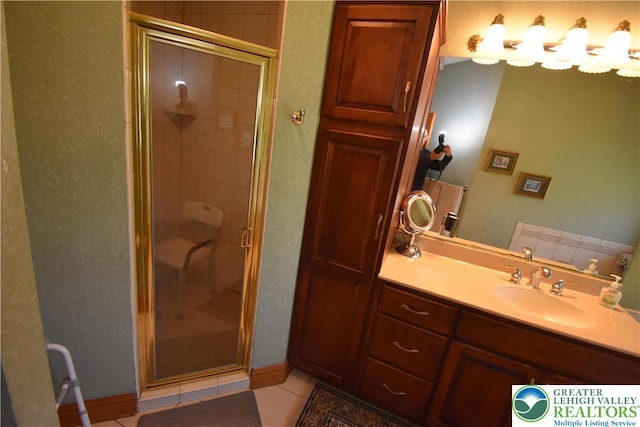 bathroom featuring vanity, tile patterned flooring, and a stall shower
