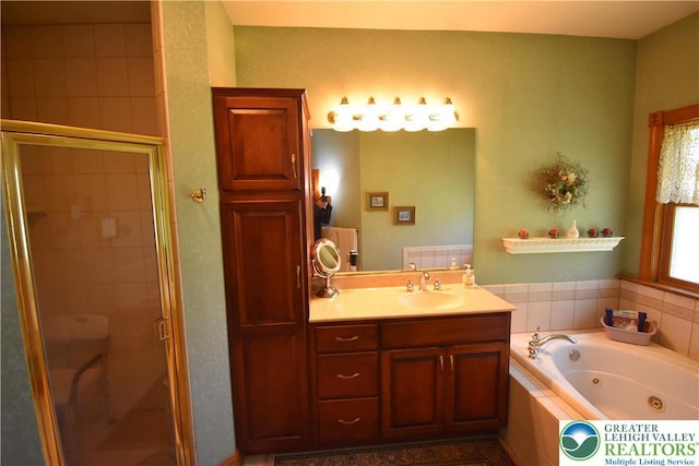 full bath featuring vanity, a whirlpool tub, and a stall shower