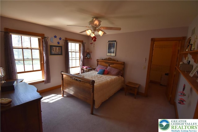 bedroom with light colored carpet, a ceiling fan, and baseboards