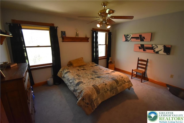 carpeted bedroom featuring baseboards and a ceiling fan