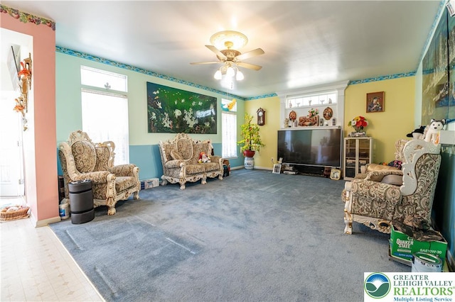 interior space with a ceiling fan and baseboards