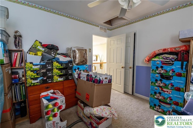 recreation room with ceiling fan, carpet, and visible vents