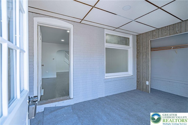 unfurnished sunroom featuring arched walkways
