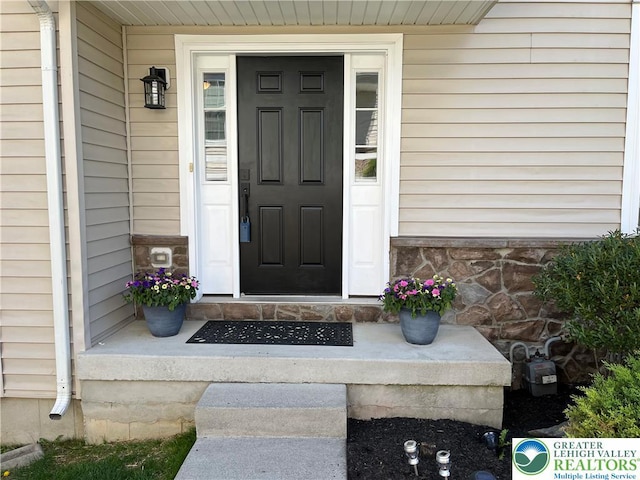 view of exterior entry featuring stone siding