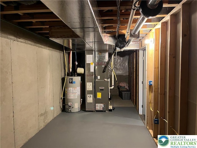unfinished below grade area featuring heating unit and gas water heater