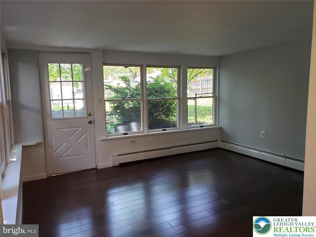entryway featuring wood finished floors and a baseboard heating unit