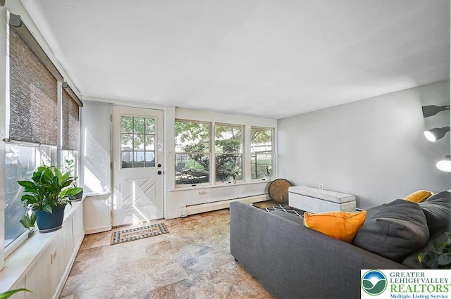 living room with stone finish floor and a baseboard radiator
