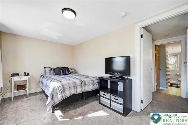 bedroom with carpet flooring and baseboards