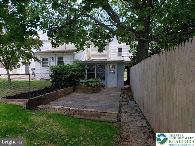 rear view of property with a patio and fence