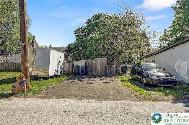 view of side of home featuring fence