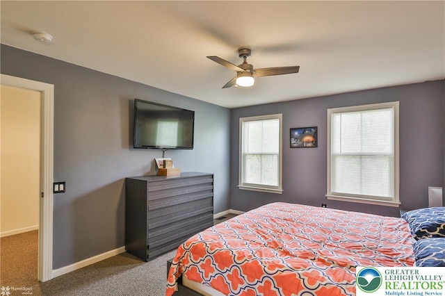 carpeted bedroom with baseboards and ceiling fan