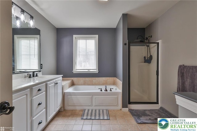 full bathroom with vanity, a bath, tile patterned floors, and a shower stall