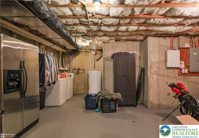 unfinished below grade area featuring water heater, stainless steel fridge with ice dispenser, electric panel, and washing machine and dryer