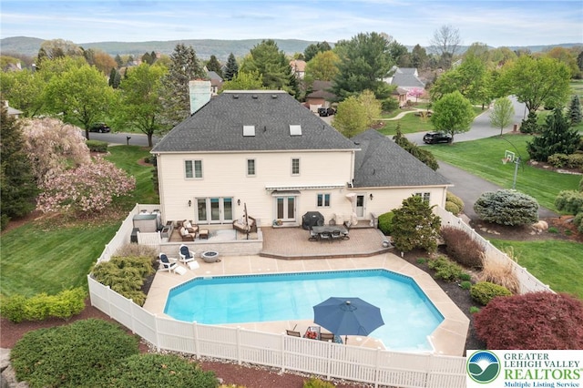 view of pool with a fenced backyard, french doors, a fenced in pool, a patio area, and outdoor dining space
