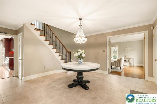 tiled foyer entrance with crown molding, baseboards, stairway, and an inviting chandelier