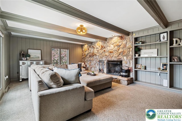 living room with carpet flooring, wooden walls, a stone fireplace, and beam ceiling