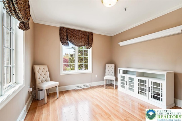 sitting room featuring baseboards, visible vents, ornamental molding, and wood finished floors
