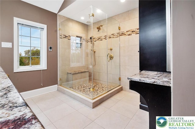 full bathroom with tile patterned floors, baseboards, and a stall shower
