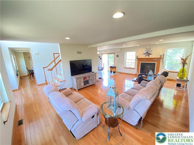 178 Stoney Ledge Dr, Jackson Twp, PA 18360 - living area with light wood finished floors, a glass covered fireplace, stairs, recessed lighting, and baseboards
