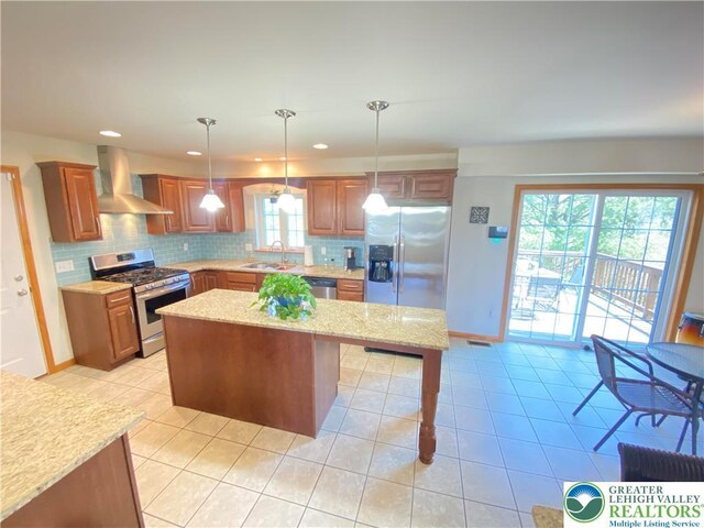 178 Stoney Ledge Dr, Jackson Twp, PA 18360 - kitchen with wall chimney range hood, backsplash, appliances with stainless steel finishes, light tile patterned floors, and a sink