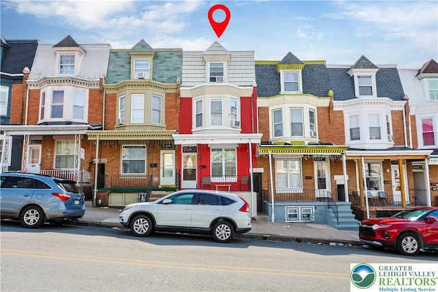multi unit property with mansard roof and brick siding