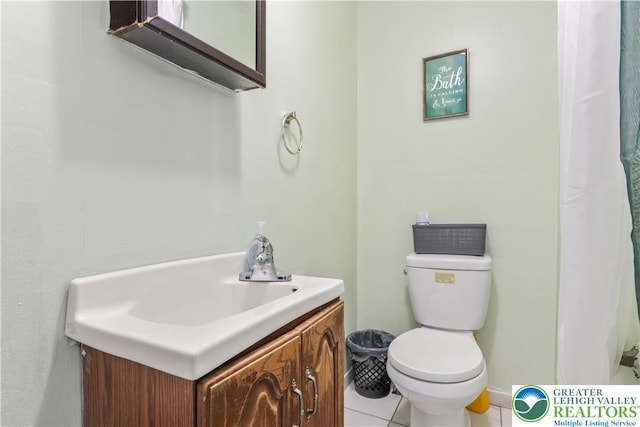 bathroom with vanity, tile patterned flooring, and toilet