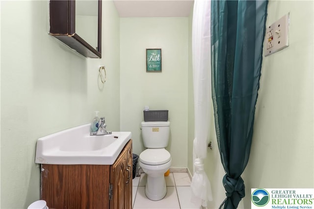 bathroom featuring tile patterned floors, vanity, and toilet
