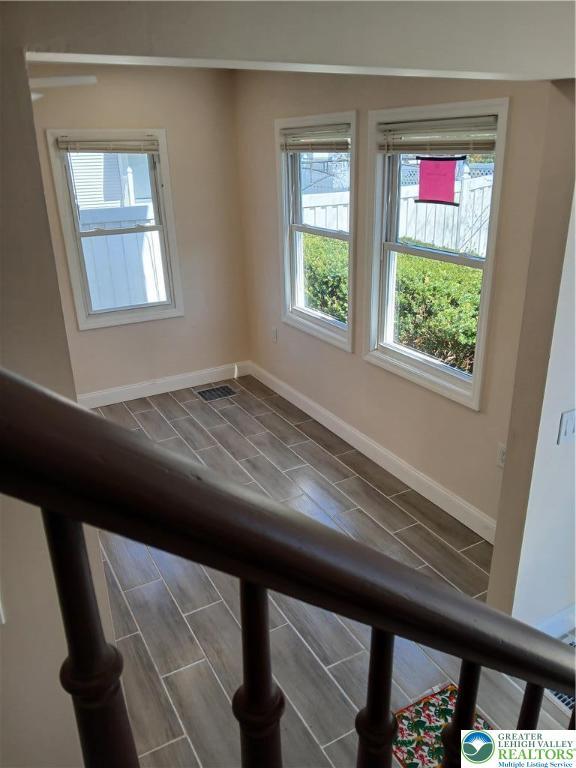 empty room with baseboards and visible vents