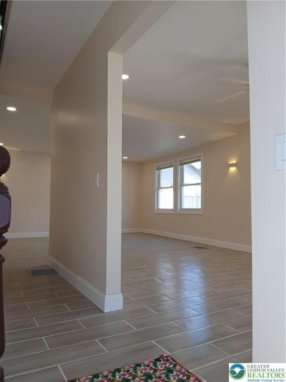 interior space featuring recessed lighting, baseboards, and wood finish floors