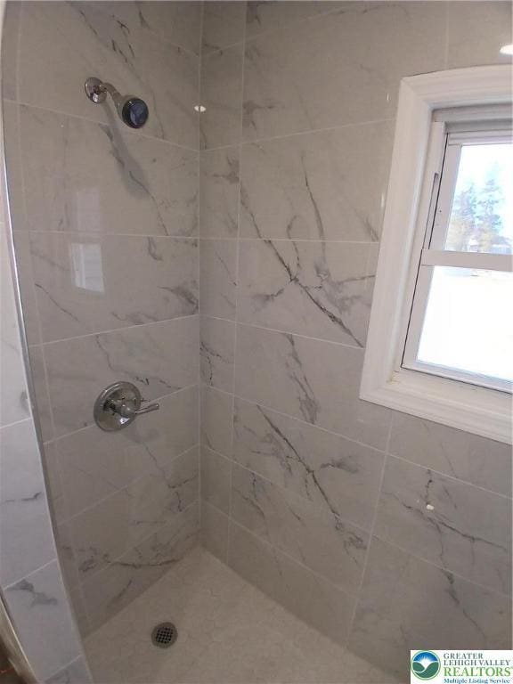 bathroom with tiled shower