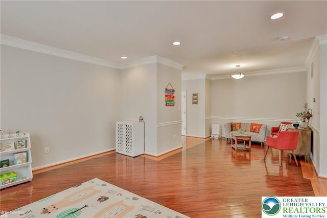 rec room featuring baseboards, recessed lighting, crown molding, and wood finished floors