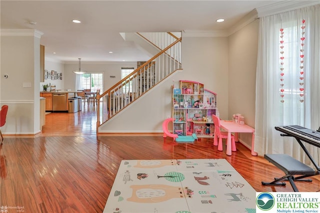 game room featuring baseboards, ornamental molding, light wood-style flooring, and recessed lighting