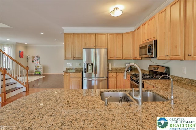 kitchen with crown molding, stainless steel appliances, light brown cabinetry, and light stone counters