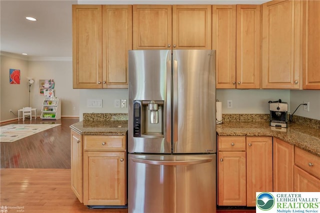 kitchen with light wood finished floors, recessed lighting, stainless steel fridge with ice dispenser, and crown molding
