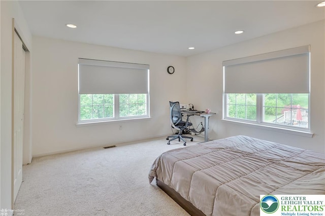 bedroom with carpet flooring, multiple windows, and recessed lighting