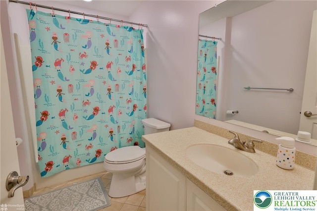 bathroom featuring toilet, tile patterned flooring, and vanity